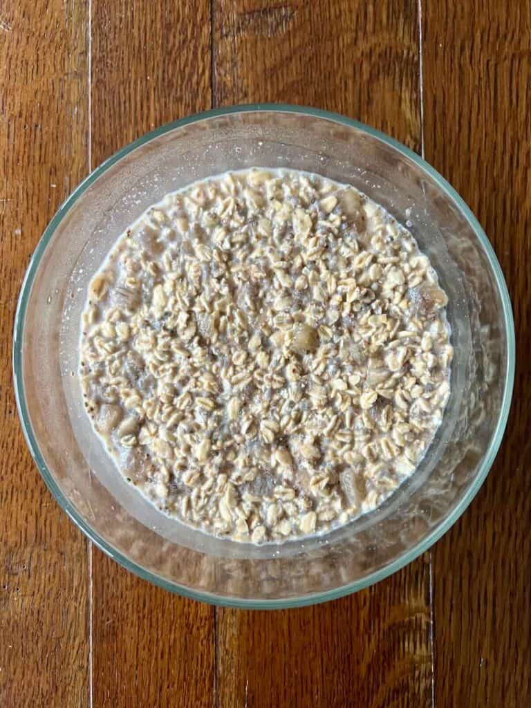 overhead view of a glass bowl containing overnight oats that have been chilled overnight