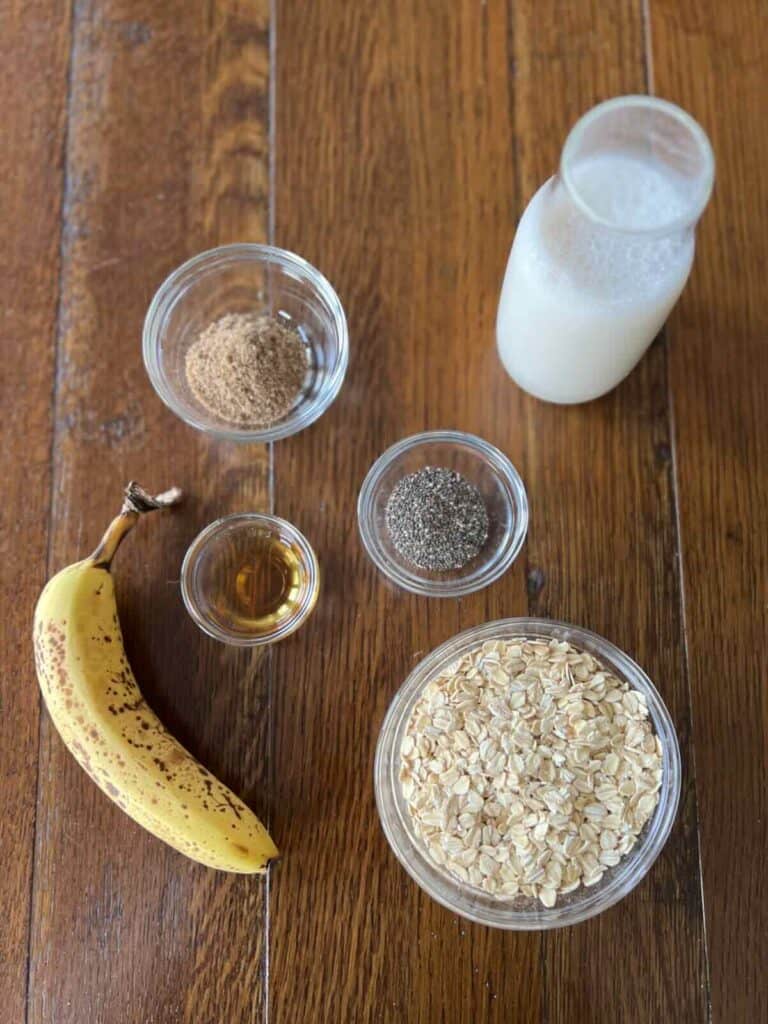 overhead photo of ingredients: oats, banana, soy milk, flaxseeds, chia seeds, maple syrup